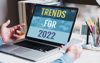 Trends for 2022 or business creativity with text and young person using conputer.