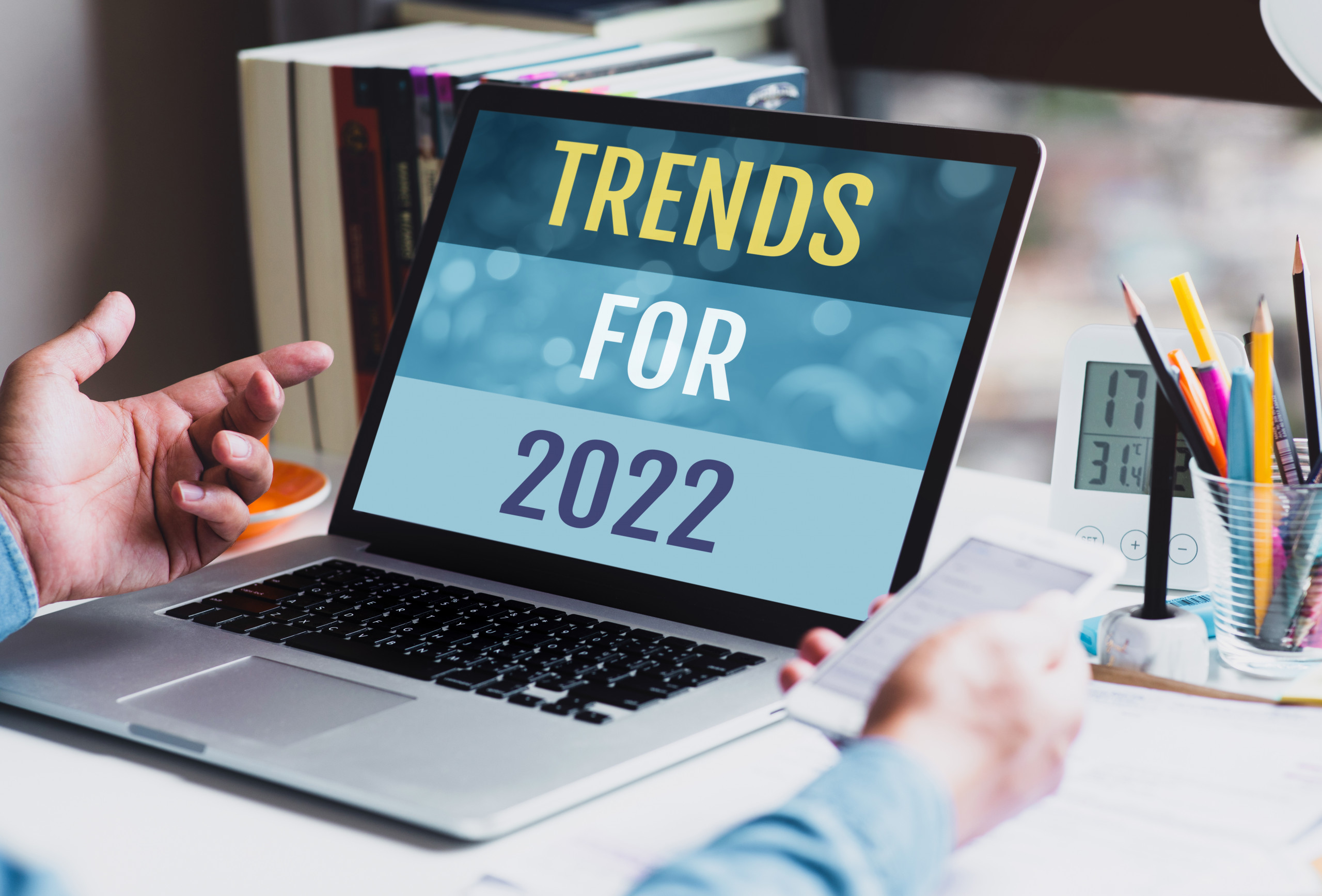 Trends for 2022 or business creativity with text and young person using conputer.